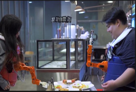 Researchers develop wearable robot arm that can feed you & your dinner companion