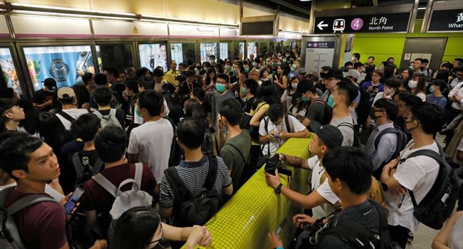 Demonstrators block train services in Hong Kong as violent protests continue